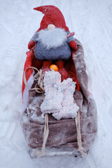 Santa Claus gnome on sleigh with tangerine and mittens Merry Christmas and Happy New Year