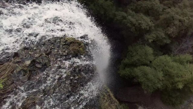 Water flowing off the edge of a cliff into a waterfall 