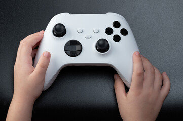 Wireless game controller in kid hand © PixieMe