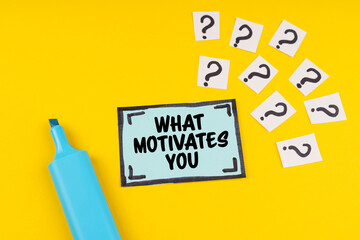 On the yellow surface is a marker, question marks and a sticker with the inscription - WHAT...