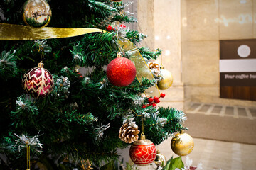 Decorated beautiful snow christmas green tree with gold light and gifts interior room decorations