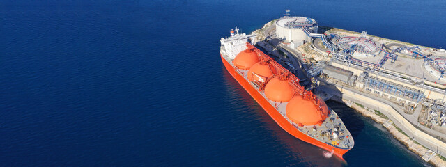 Aerial drone ultra wide panoramic photo of LNG (Liquified Natural Gas) tanker anchored in small gas...
