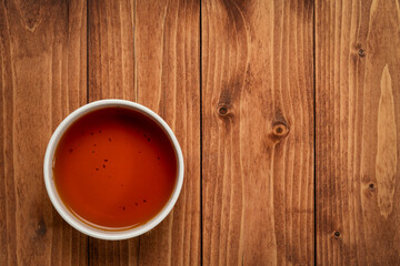 top view of red rooibos tea cup on wooden table