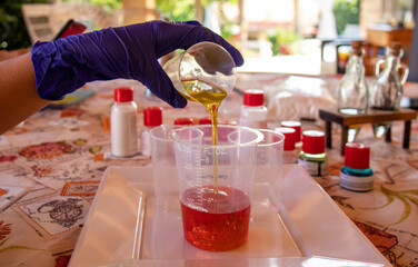Girl doing a lava lamp formation experiment. In the background, all products and substances used