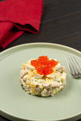 Russian winter salad with quail eggs and red caviar
