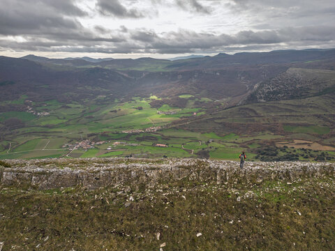 Hiker on the Txurregi crest looking at the Ollo Valley