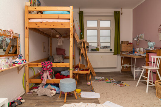 Mess in the children's room. Scattered things and toys, books. Parenting