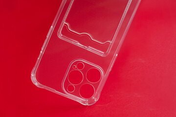 Close -up silicone transparent case for a smartphone on a red background