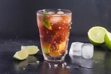 Rum cola cocktail on dark background