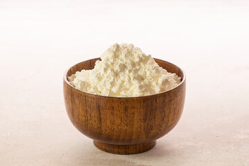 Corn flour in wooden bowl close up