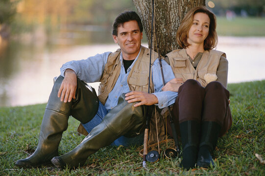 Portrait of Couple Sitting Under a Tree, With Fishing Gear