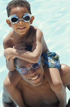 Portrait of Father and Son In Swimming Pool