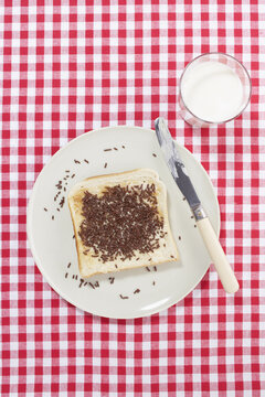 Toast Sprinkled with Chocolate on Plate with Glass of Milk