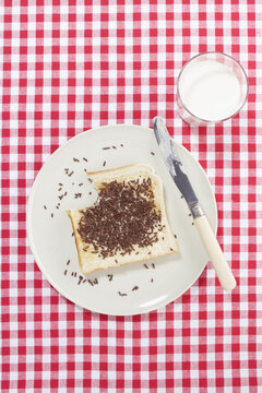 Toast Sprinkled with Chocolate on Plate with Glass of Milk