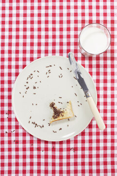 Plate with Bite of Toast and Glass of Milk