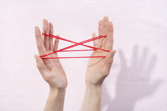 Woman Playing Cat's Cradle