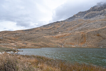 Autumn landscape in the mountains on hike from the hamlet of Les Cours to Lac du Pontet and back, near Villar d'Arene and Col du Lautaret, Hautes-Alpes, France