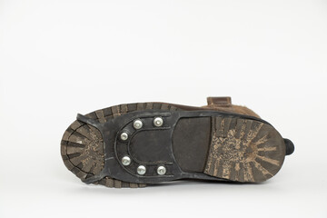 Winter boots with spikes on shoes against slipping in ice, spikes on shoes for safety, shoes