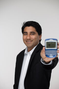 Portrait of Man Holding Personal Digital Assistant