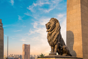 The massive statue of the lion decorates the Qasr El Nil bridge, connecting Cairo Downtown with Gezira Island in Cairo, Egypt - obrazy, fototapety, plakaty
