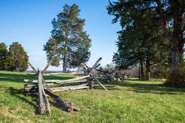 Fototapeta na wymiar Fence on meadow with tree in the background on Henry Hill, Bull Run, Mannassas, Virginia.