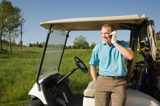 Man using Cell Phone on Golf Course