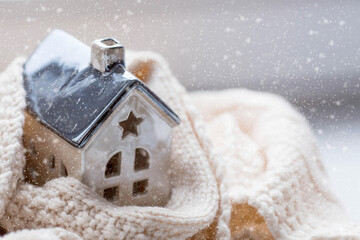 A house wrapped in a scarf. Winter. Home insulation, protection from cold and bad weather, room...