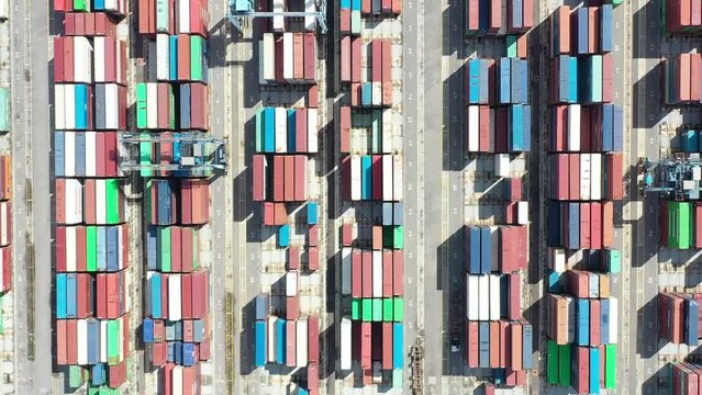Aerial top view footage of container terminal. Industrial cargo port. Logistic center of the Asian economy.  Container in import export logistic business and international freight transportation. 