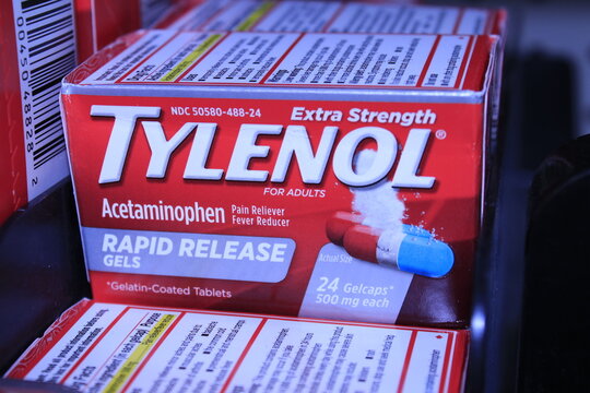 TYLENOL in boxes on a shelf at a store.