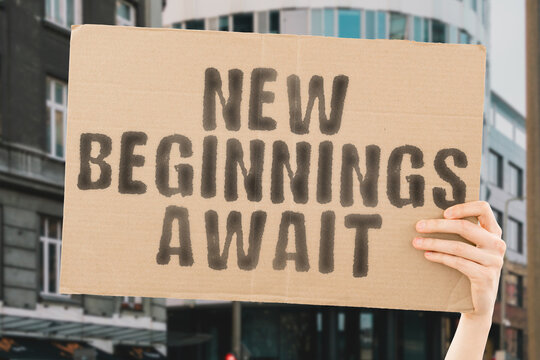 The phrase " New Beginnings Await " is on a banner in men's hands with blurred background. Plan. Time. Celebration. Ahead. Begin. Challenge. Date. Planning. Purpose. Success. Target. Trend
