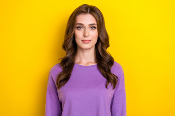 Portrait of young adorable cute brown curly hairstyle lady wear purple pullover calm face after beauty salon isolated on yellow color background