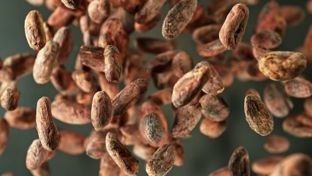 Super slow motion of rotating cocoa beans and powder. Filmed on high speed cinema camera, 1000 fps placed on high speed cine bot.  Camera moving up with rotation.