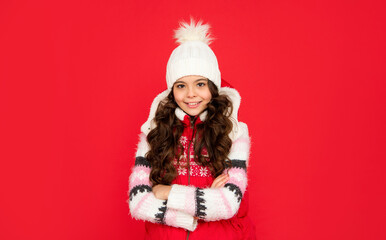 teen girl crossed hands on red background. portrait of child wearing warm clothes.