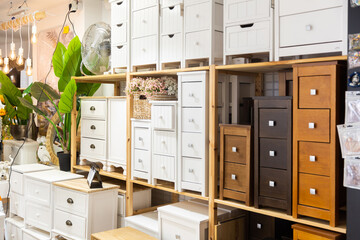 Interior of modern furnishings store with wooden cabinets with drawers for sale