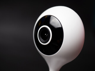 Picture of a white table top IP CCTV camera with modern design on a black background