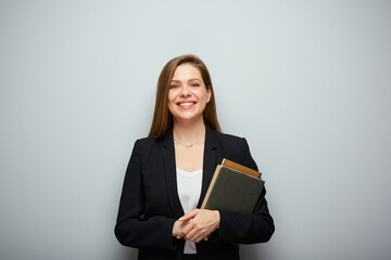 Smiling woman teacher or student in black suit holding book. Isolated portrait with copy space.