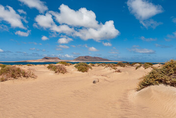 Fototapeta na wymiar sand dunes and blue sky with clouds