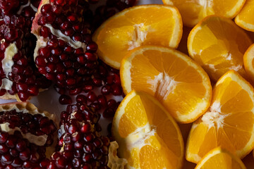 Close-up of oranges and pomegranates. - Powered by Adobe