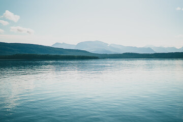 Beautiful fjord in Norway on a bright day with blue sky and mountains in the background