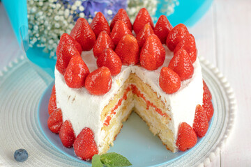 Taking of delicious strawberry cake from plate by using shovel, closeup. selective focus. festive berry cake. homemade strawberry cake cut. 