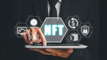 NFT token digital crypto art blockchain technology concept, Person hand using digital tablet with NFT icon on virtual screen.