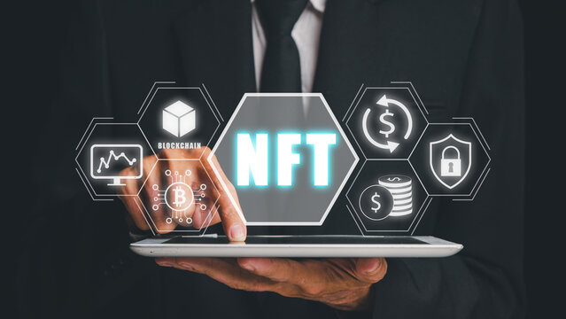 NFT token digital crypto art blockchain technology concept, Person hand using digital tablet with NFT icon on virtual screen.