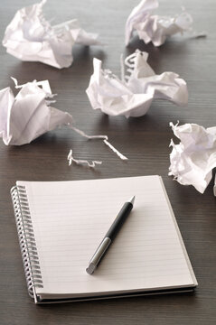 Pen on Notebook with Pages Crumpled