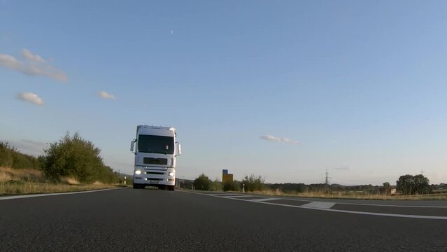 Semi trucks van cargo and parcel delivery driving on a highway. White Van delivers goods in early hours of the Morning 