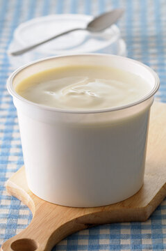 Close-up of Creme Fraiche on Cutting Board on Gingham Background, Studio Shot