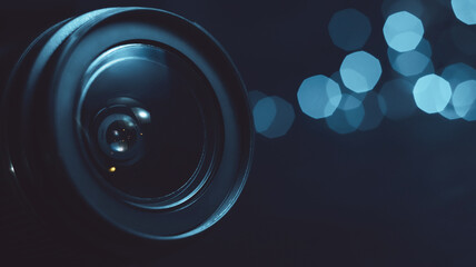Camera lens close-up, lights out of focus on the background, cyan color