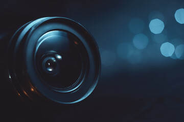 Camera lens close-up, lights out of focus on the background, cyan color