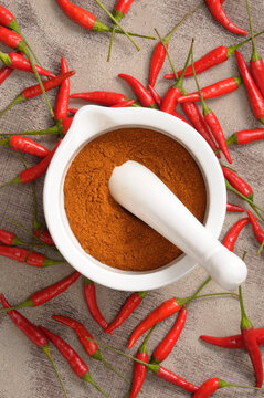 Overhead View of Hot Red Peppers and Ground Peppers in Mortar and Pestle