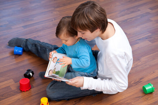 Boy Reading to Younger Brother
