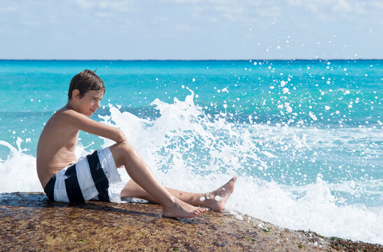 Boy Sitting by Surf, Playa del Carmen, Yucatan Peninsula, Mexico